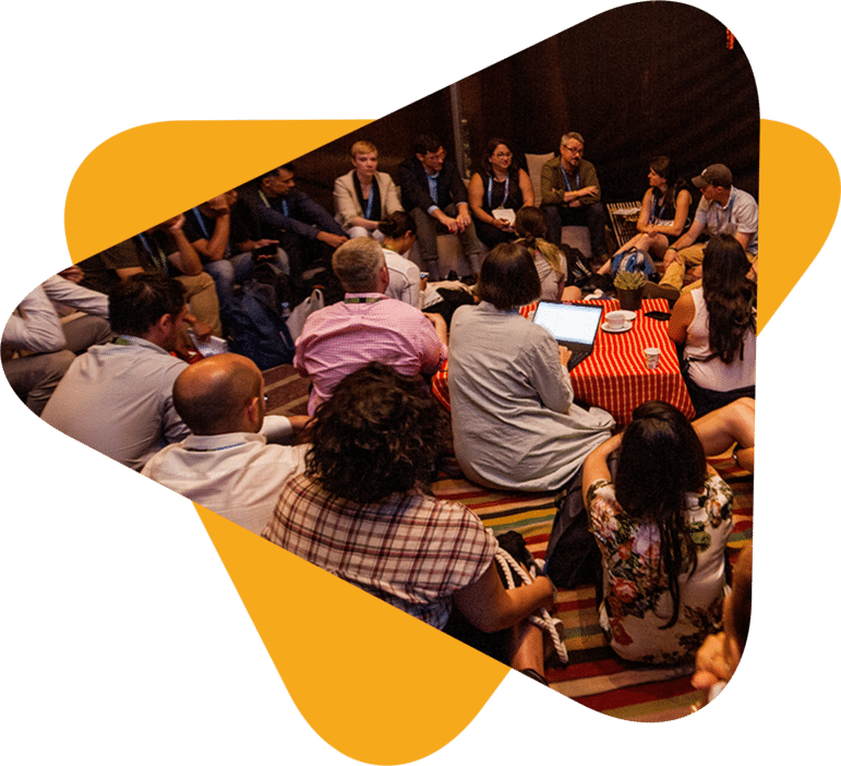 Group of people attending RightsCon at a roundtable.