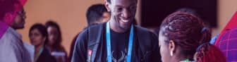two people happily talking during RightsCon
