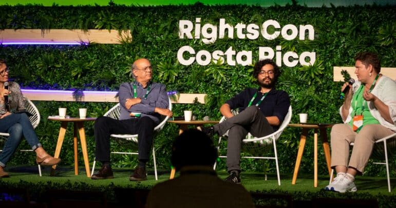 A session on a stage in Costa Rica with 4 people sitting and talking